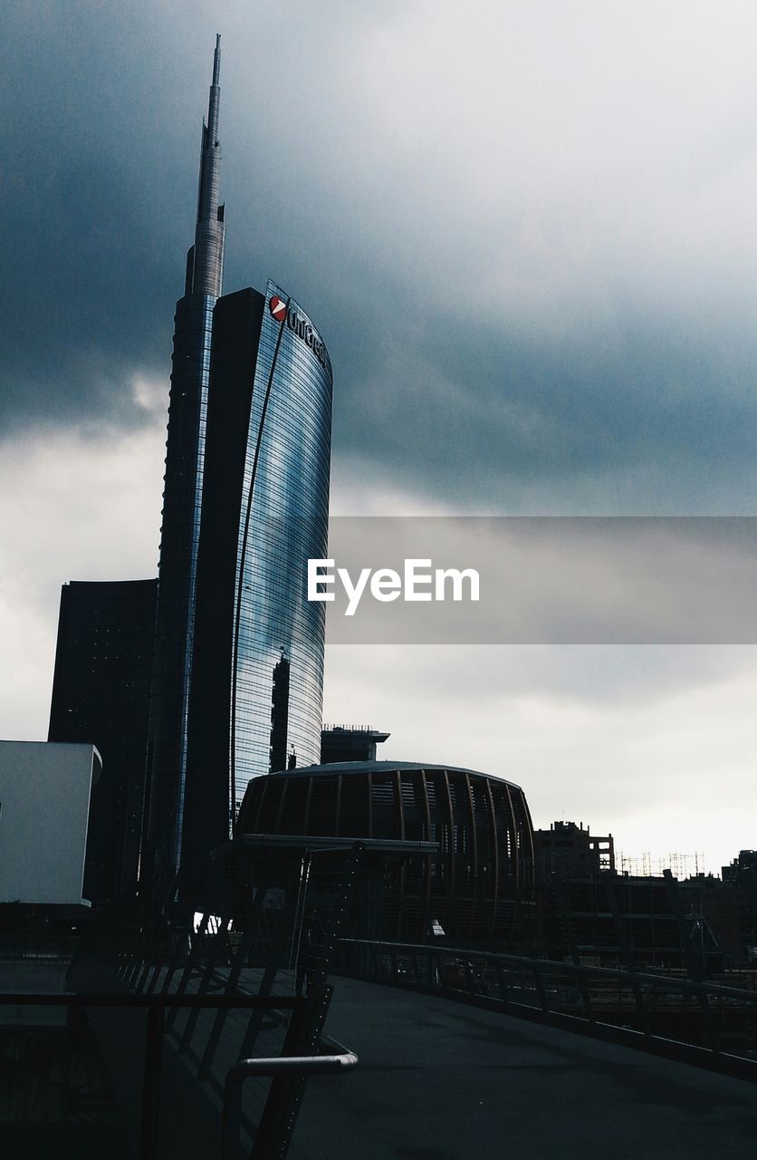 SKYSCRAPERS AGAINST CLOUDY SKY