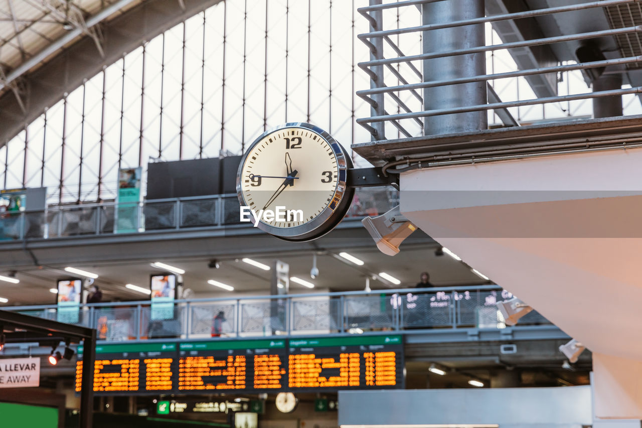 Low angle view of illuminated clock on train station