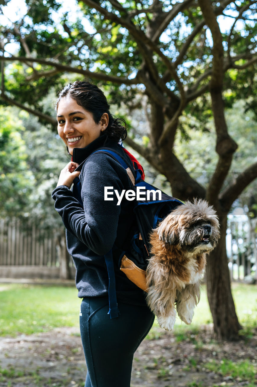 Portrait of smiling young woman with dog