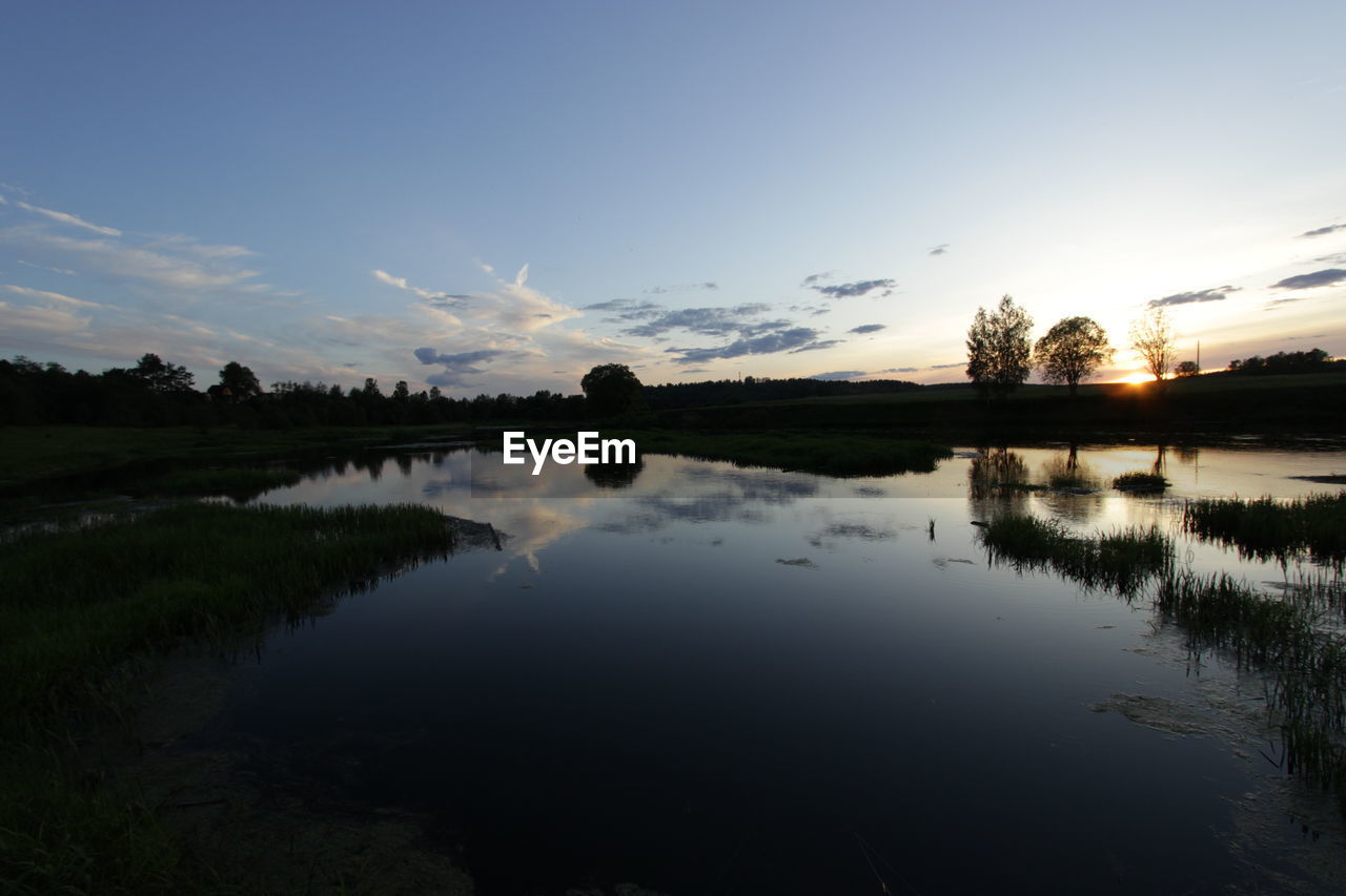 Scenic view of lake at sunset