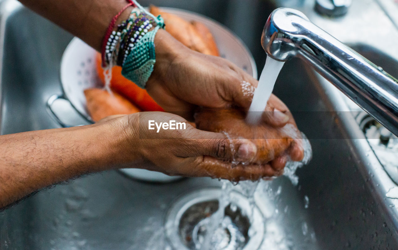 Man washing sweet potato