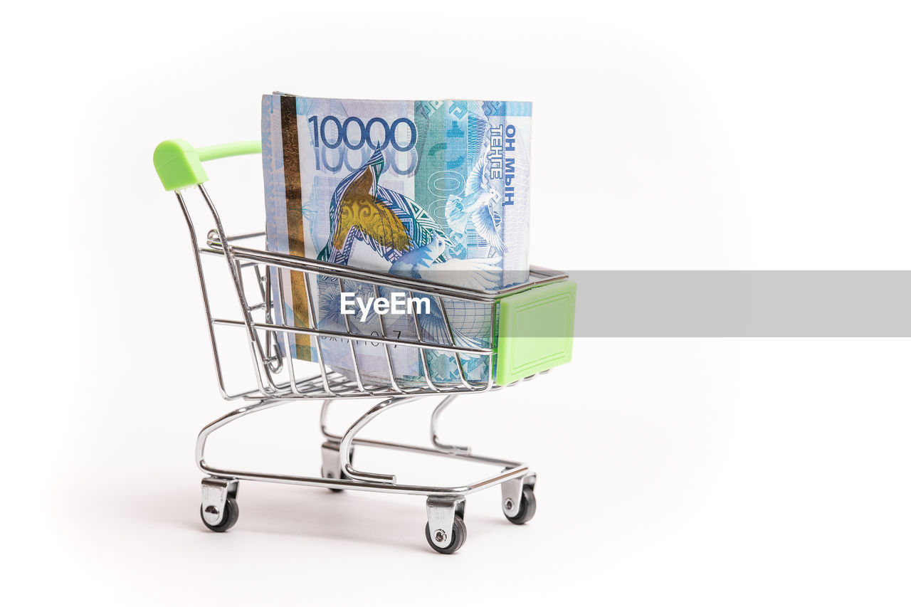 shopping cart, shopping, consumerism, cart, retail, finance, buying, business, currency, supermarket, paper currency, vehicle, store, cut out, studio shot, finance and economy, white background, business finance and industry, sale, no people, cartoon, wealth, indoors, furniture, groceries