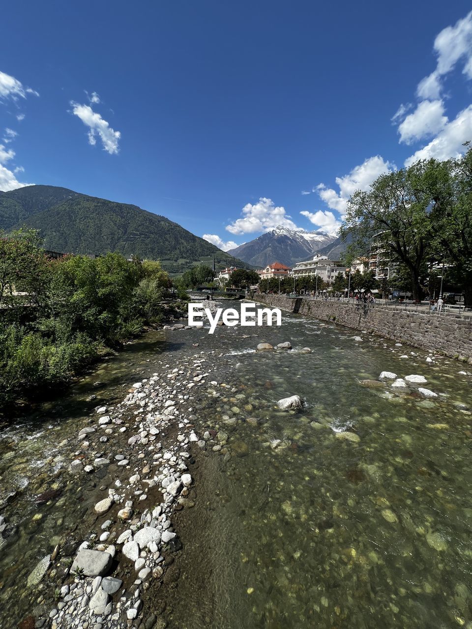 nature, sky, reflection, cloud, tree, plant, mountain, sunlight, day, beauty in nature, water, no people, outdoors, environment, scenics - nature, blue, mountain range, low angle view, land, rock, tranquility, landscape