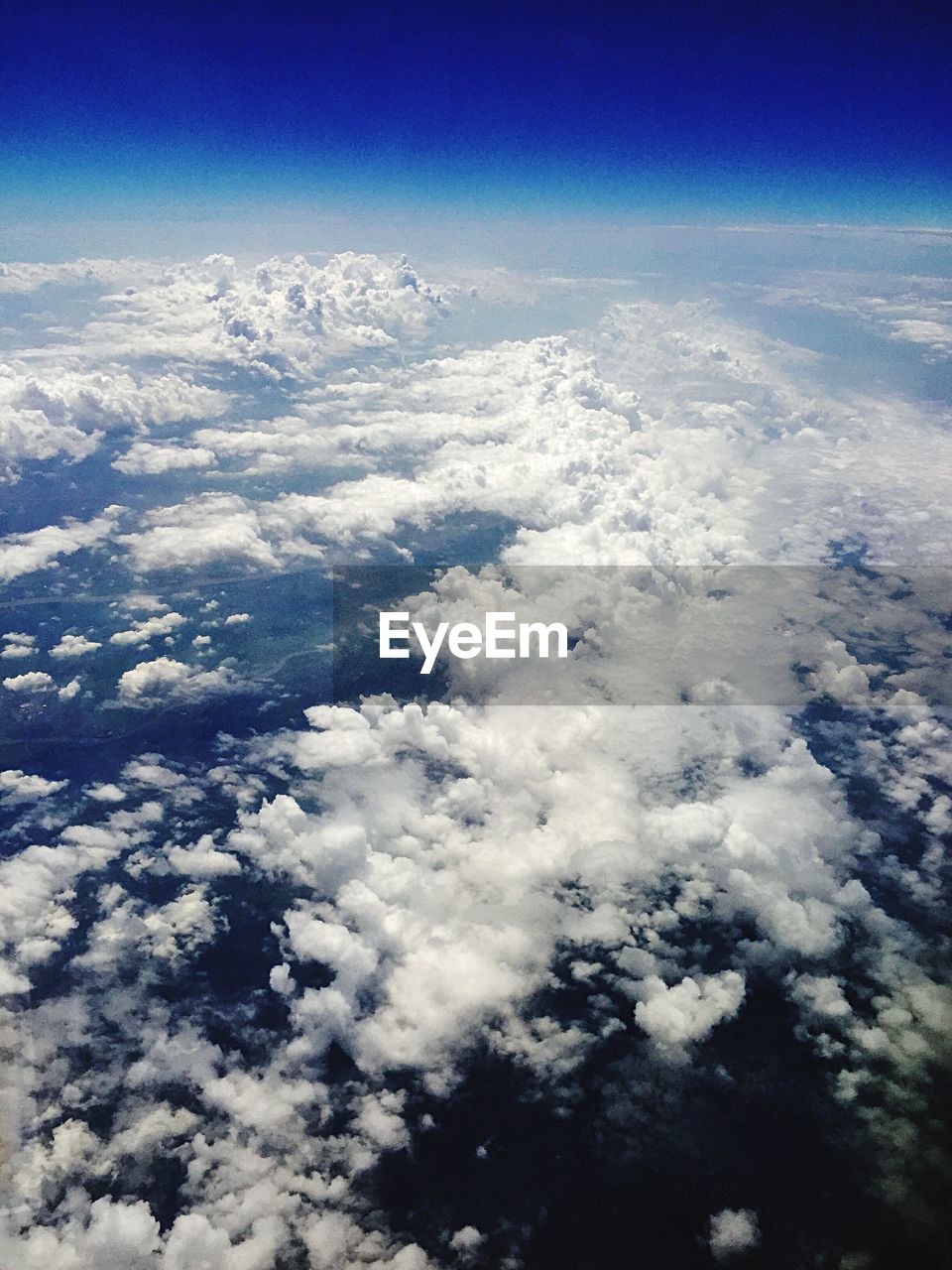 AERIAL VIEW OF MOUNTAINS AGAINST CLOUDY SKY