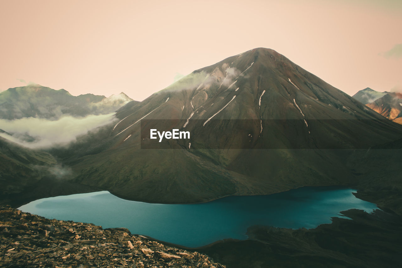 Scenic view of lake and mountains against sky