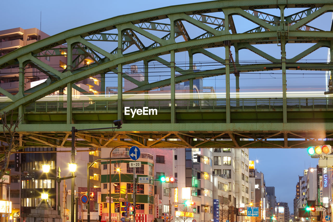 Akihabara electric town, tokyo, japan - train on elevated bridge and illuminated buildings .