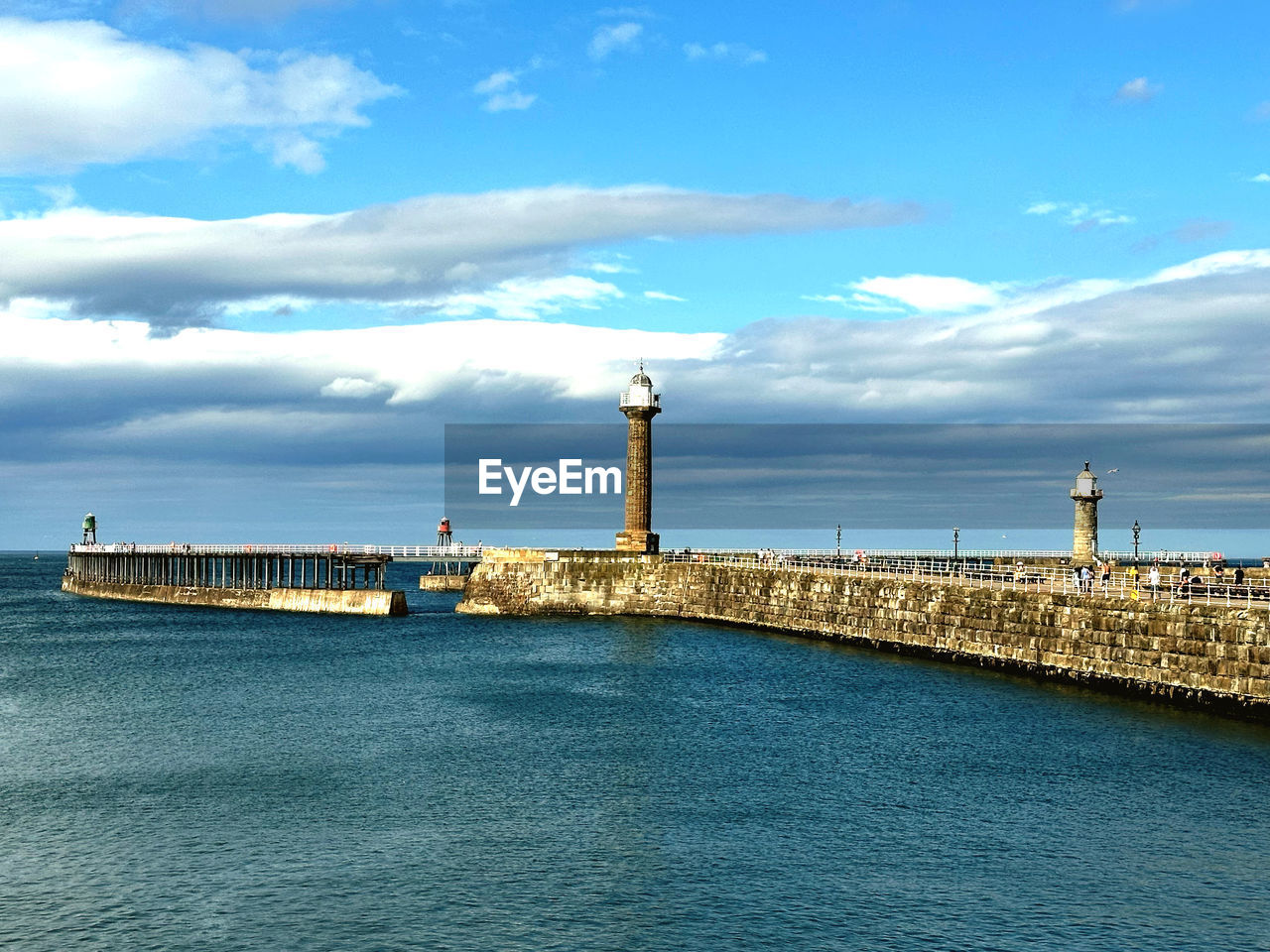 lighthouse, water, architecture, built structure, sky, tower, sea, cloud, building exterior, coast, guidance, horizon, nature, ocean, building, channel, breakwater, transportation, travel destinations, blue, travel, pier, day, shore, bay, no people, outdoors, protection, land, city, security, harbor, beach, scenics - nature, waterfront, nautical vessel, beauty in nature, tourism