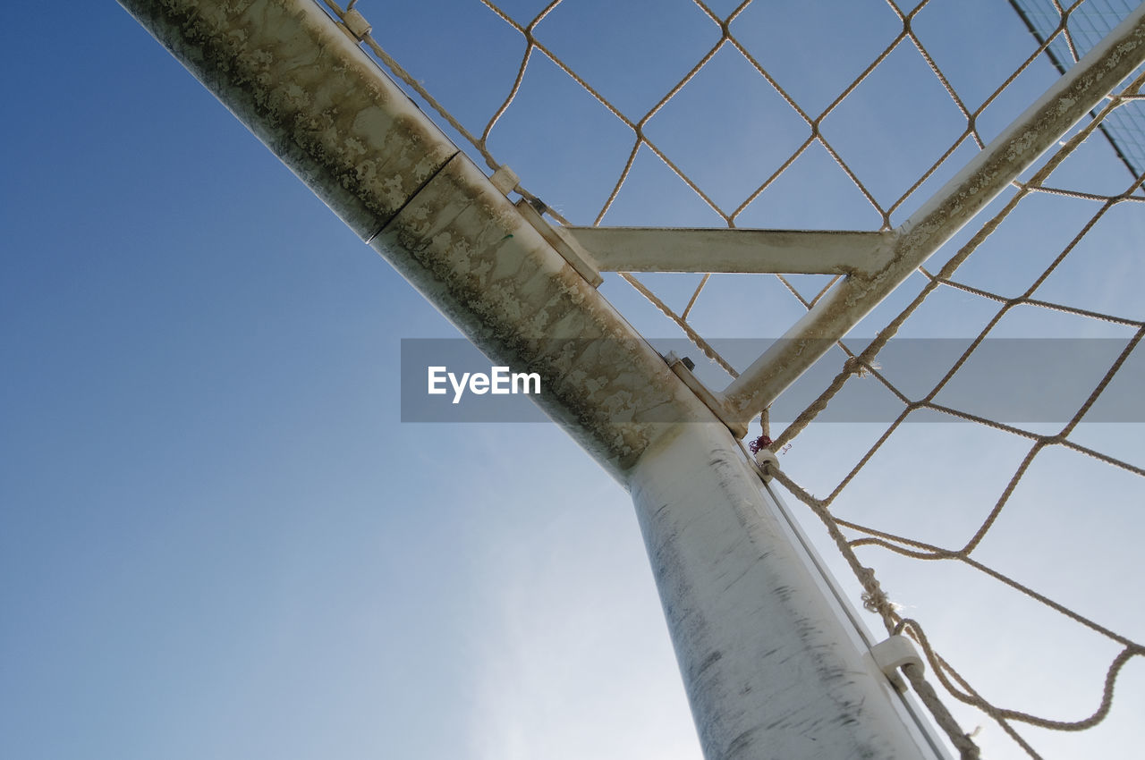 Low angle view of goal against sky