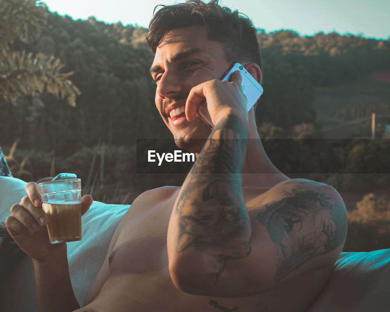 PORTRAIT OF YOUNG MAN DRINKING WATER FROM OUTDOORS