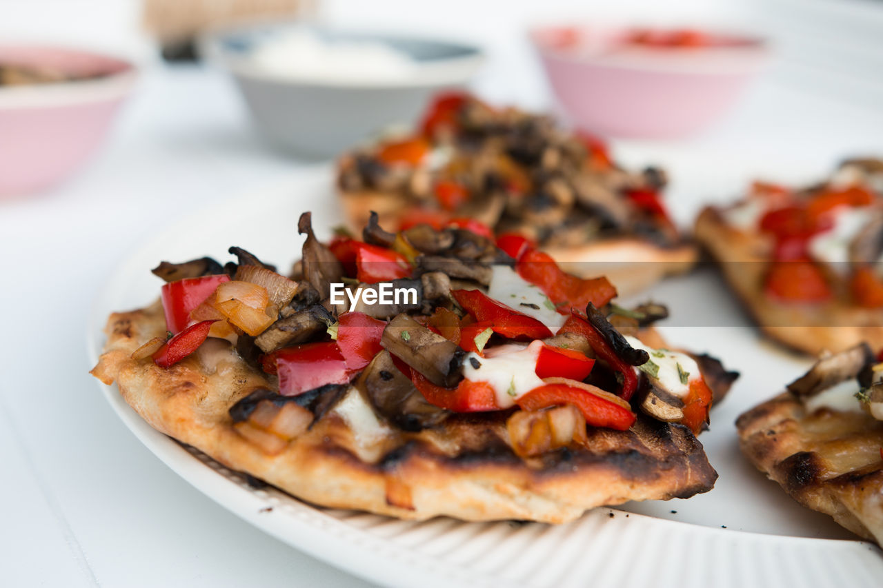 Close-up of pizzas in plate on table