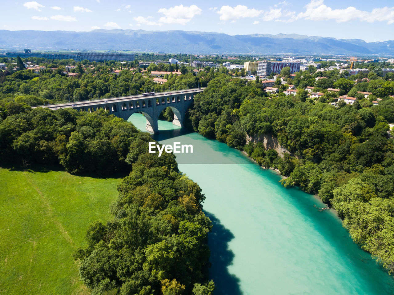 Aerial view of arch bridge over river amidst trees