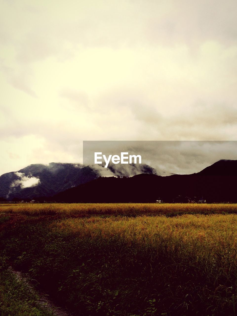 SCENIC VIEW OF MOUNTAINS AGAINST CLOUDY SKY