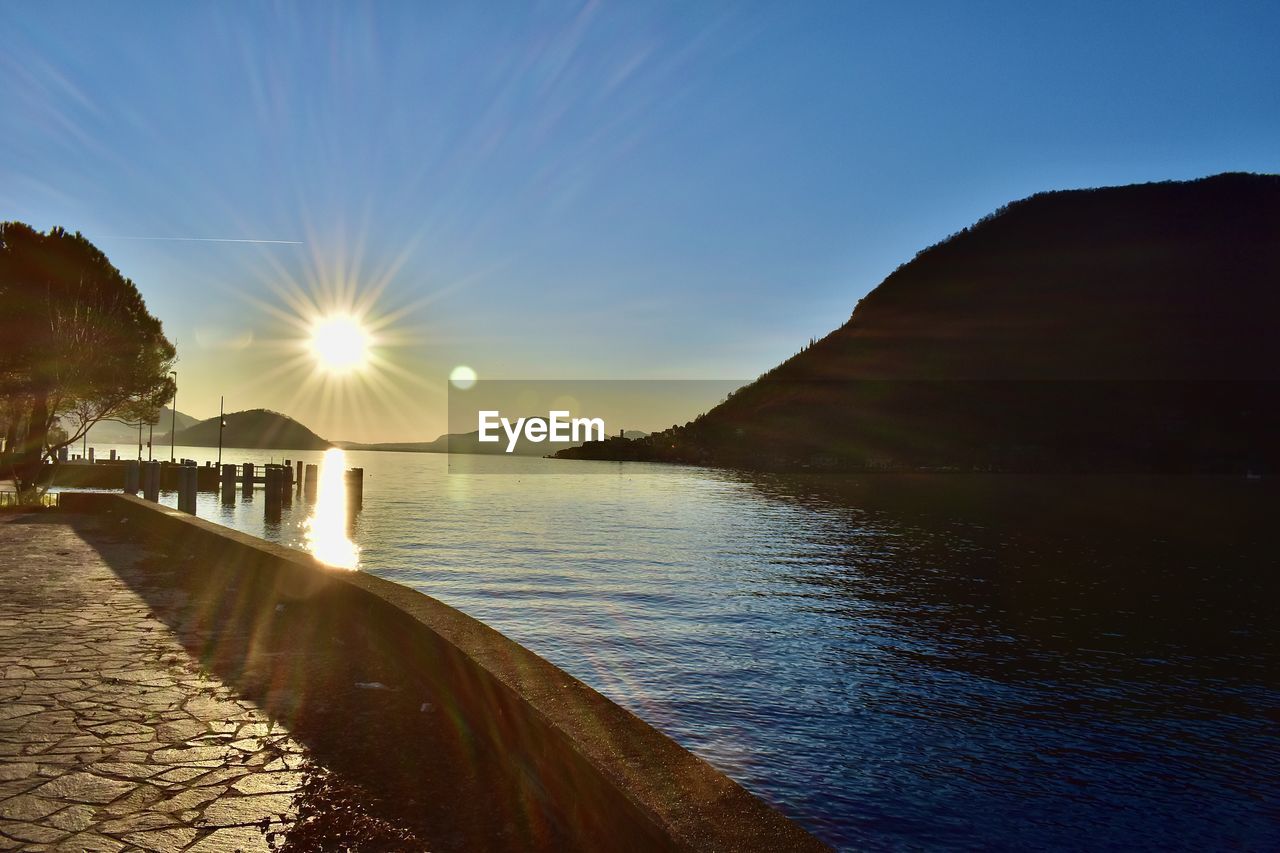 SCENIC VIEW OF SEA AGAINST BRIGHT SUN