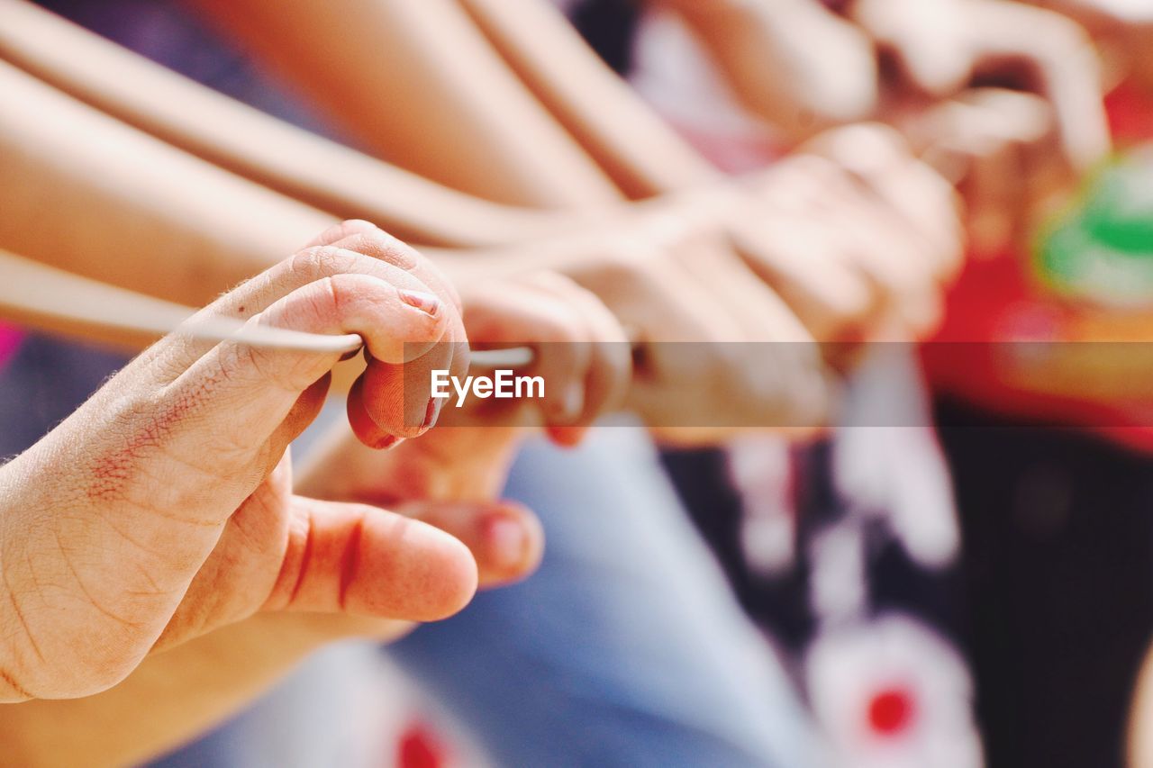 Close-up of hands holding rope