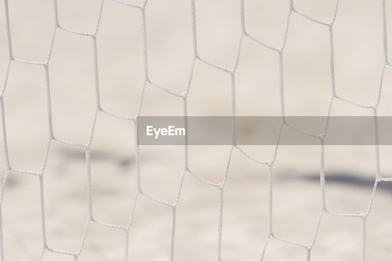 FULL FRAME SHOT OF WHITE FENCE WITH UMBRELLA