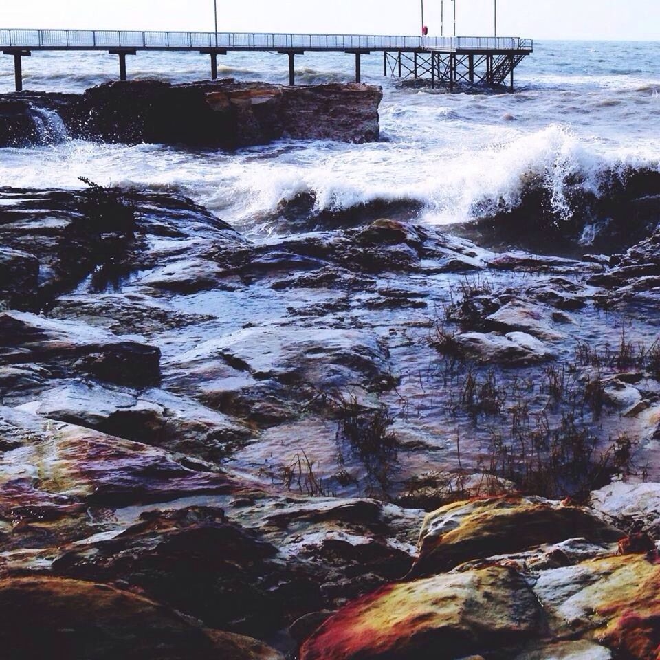 SCENIC VIEW OF SEA WITH ROCKS IN BACKGROUND