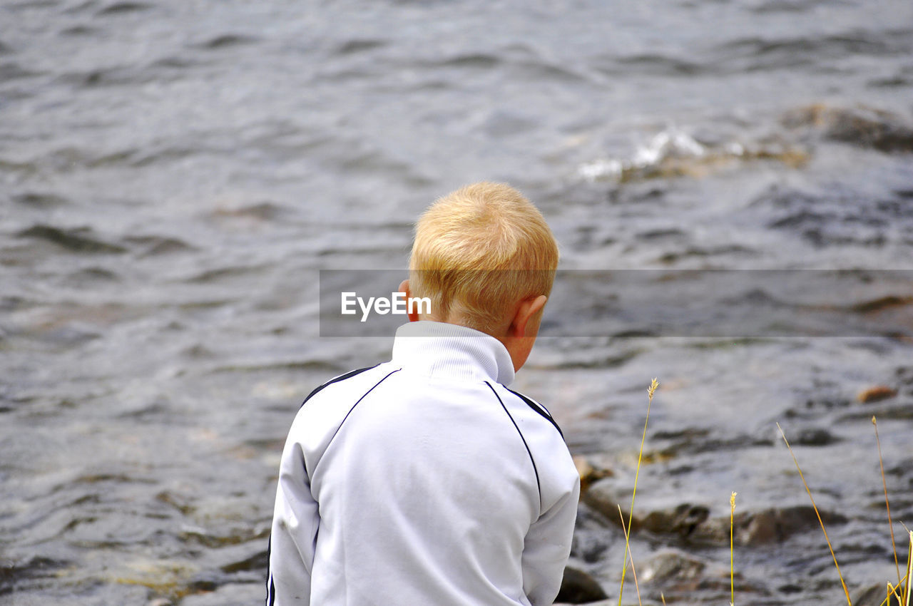 Boy standing on the shoreline 