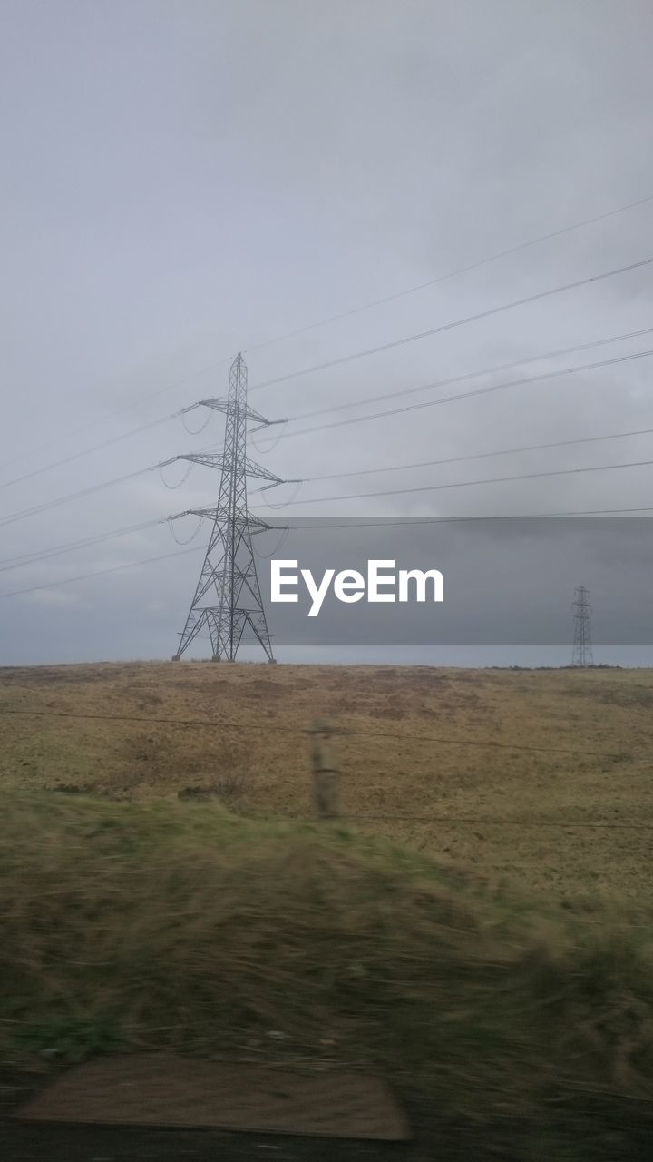 ELECTRICITY PYLONS ON FIELD