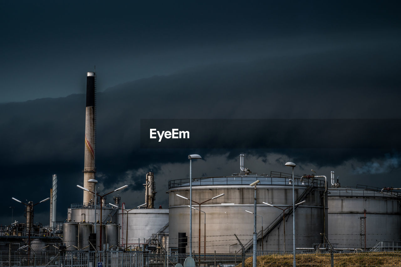 Storm clouds over crossbridge energy fredericia refinery, denmark