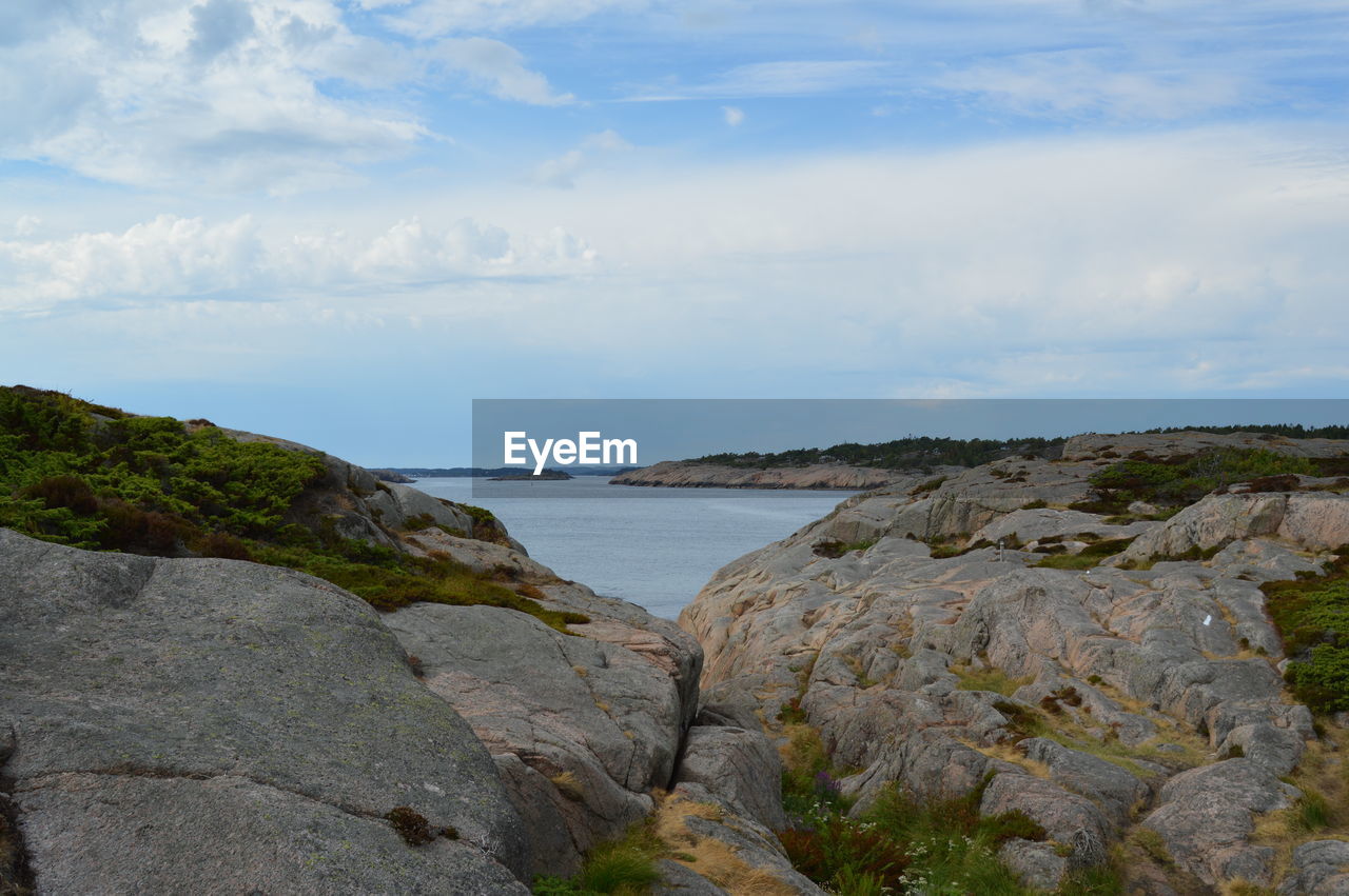 Rocks on beach against sky