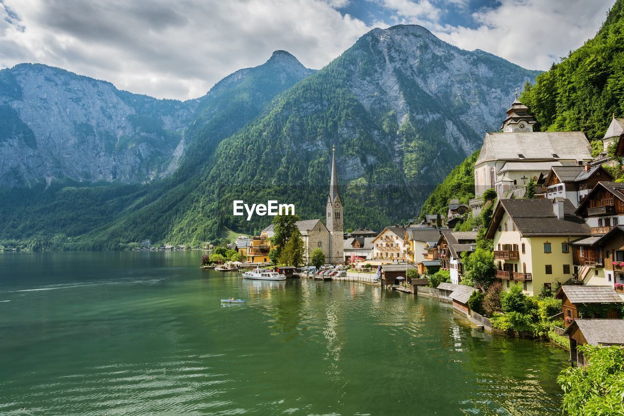 Scenic view of river with mountain range in background