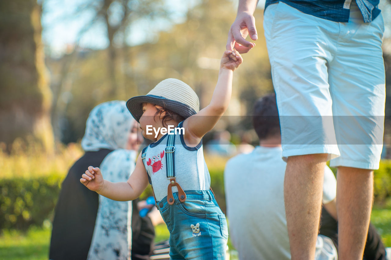 PEOPLE STANDING OUTDOORS