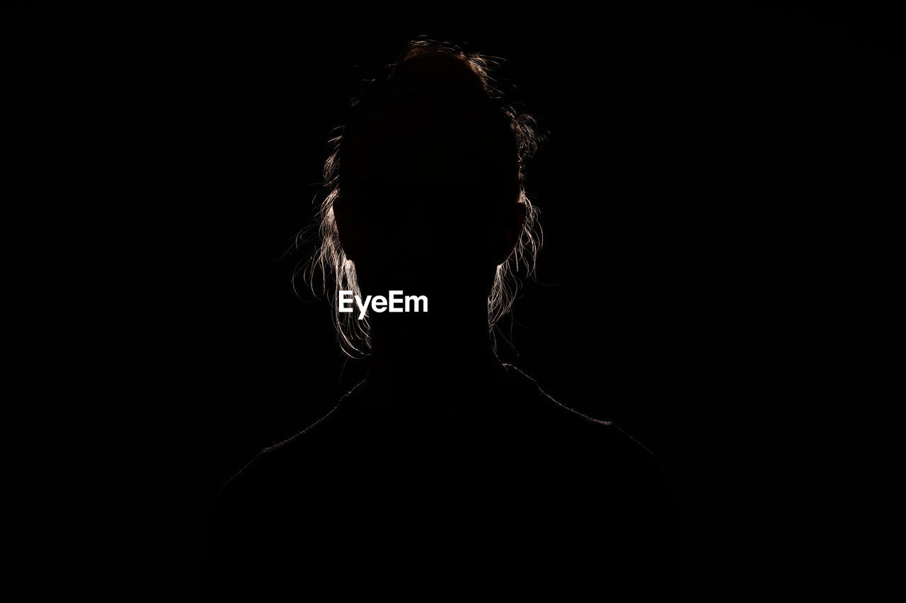 FULL LENGTH PORTRAIT OF SILHOUETTE WOMAN AGAINST BLACK BACKGROUND