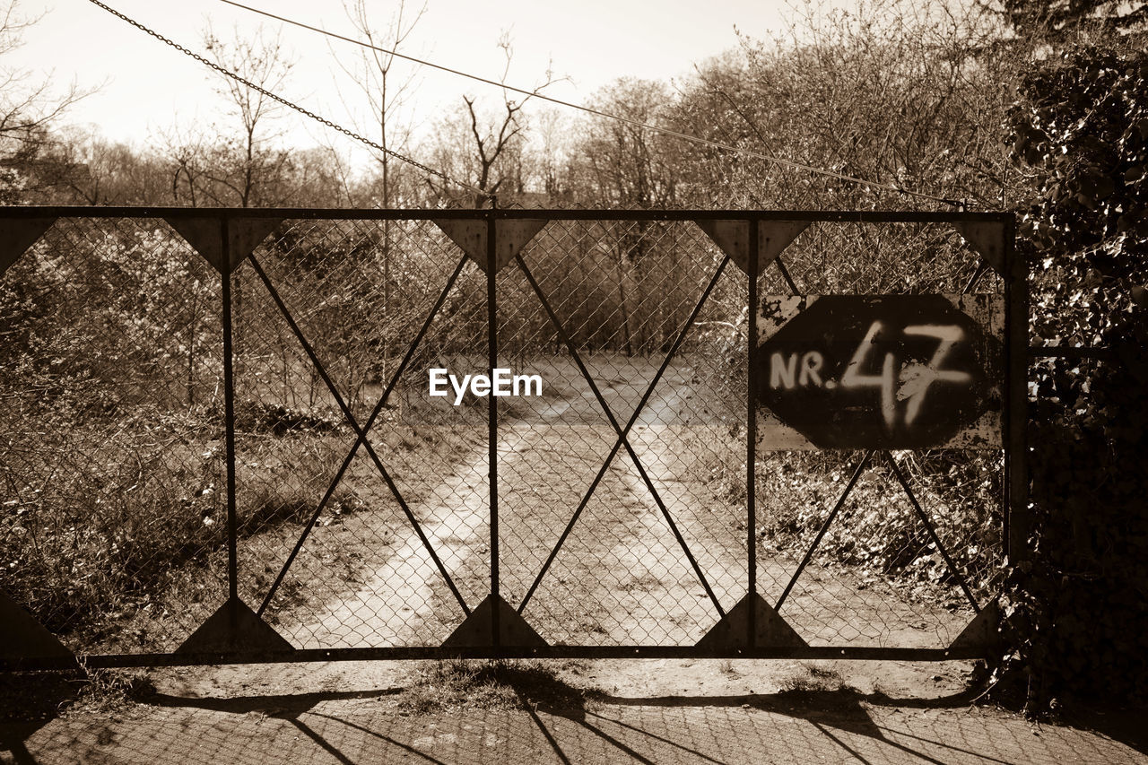 FENCE ON FIELD AGAINST TREES