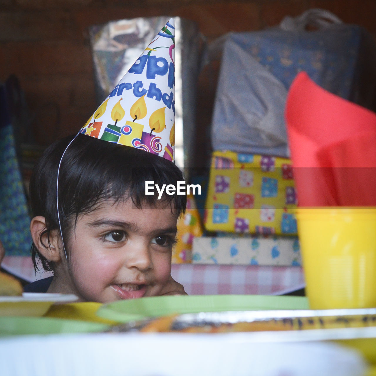 Close-up of boy wearing party hat at home