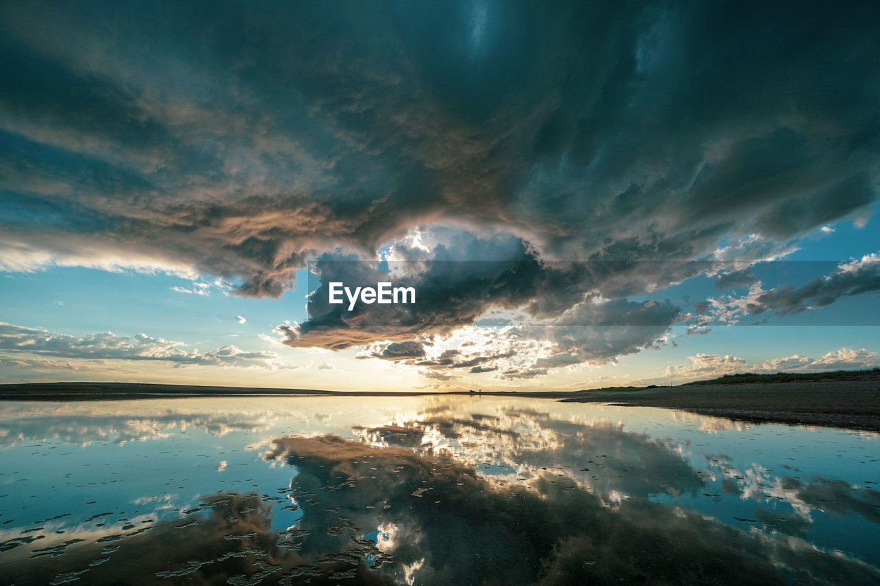 Scenic view of lake against dramatic sky