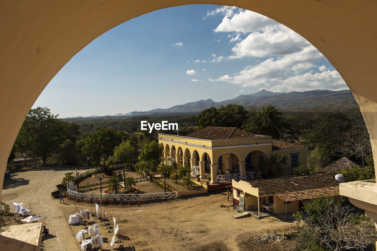 PANORAMIC VIEW OF CASTLE BY MOUNTAINS AGAINST SKY