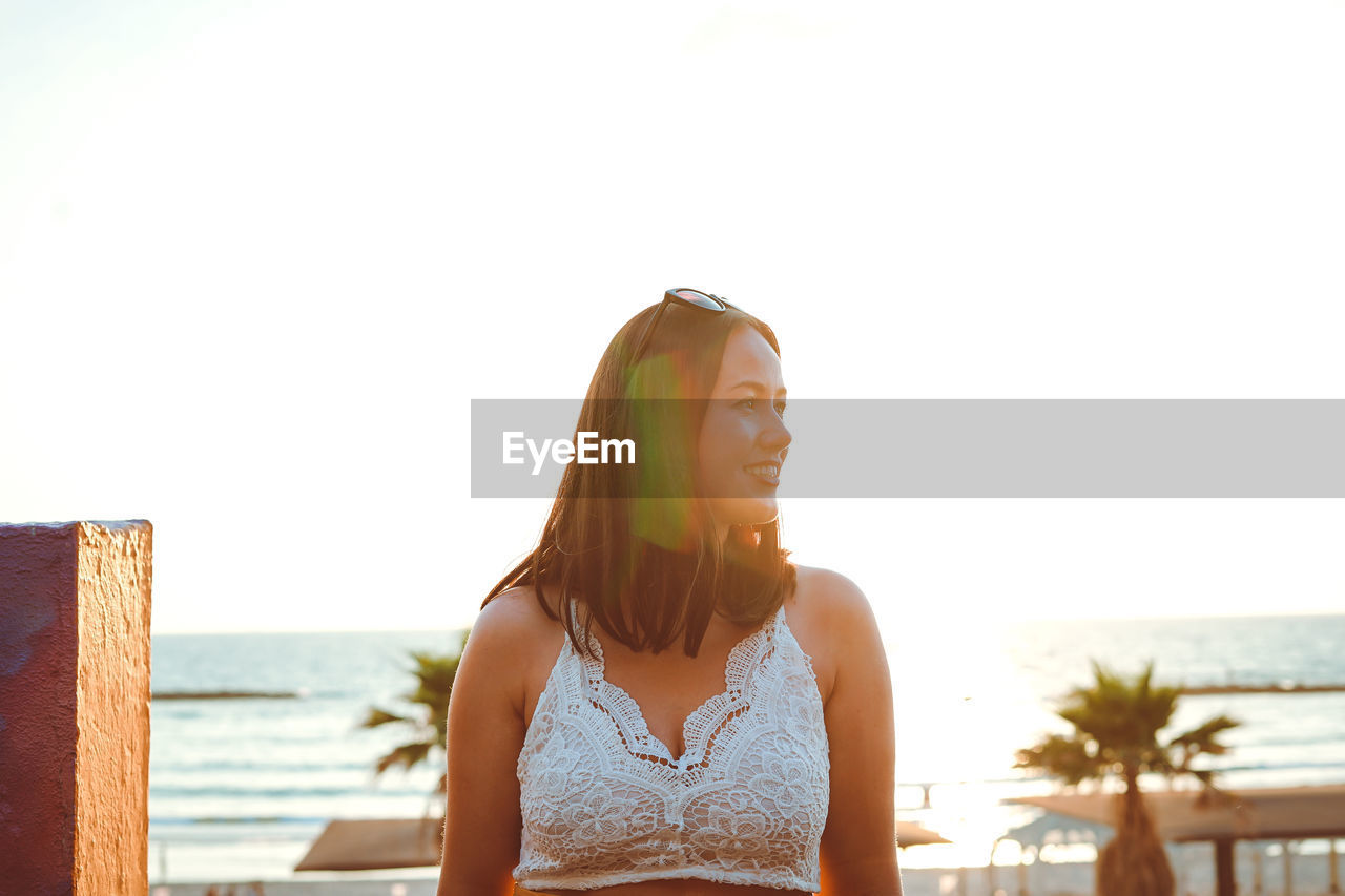 Smiling woman against sea