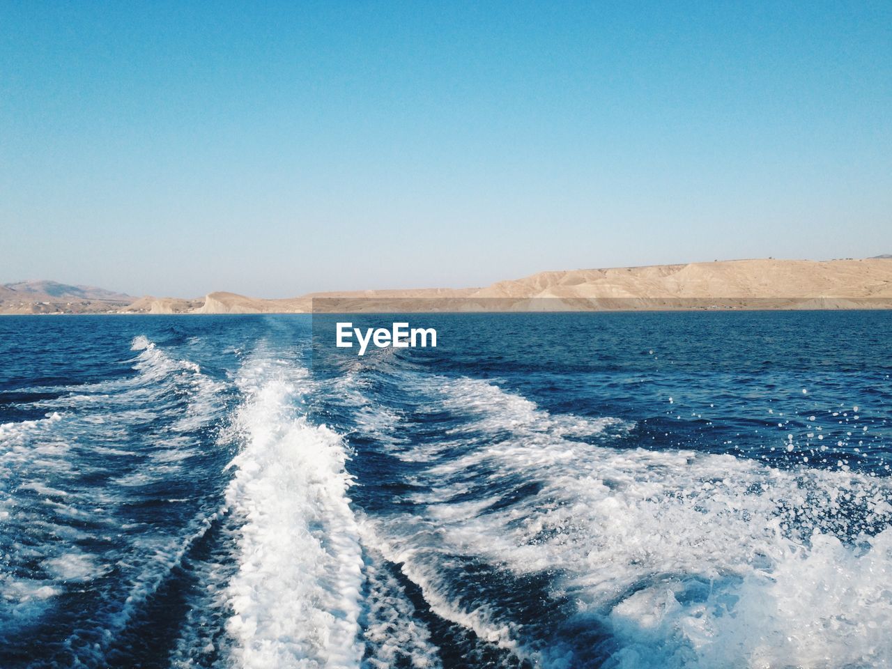 Scenic view of sea against clear blue sky