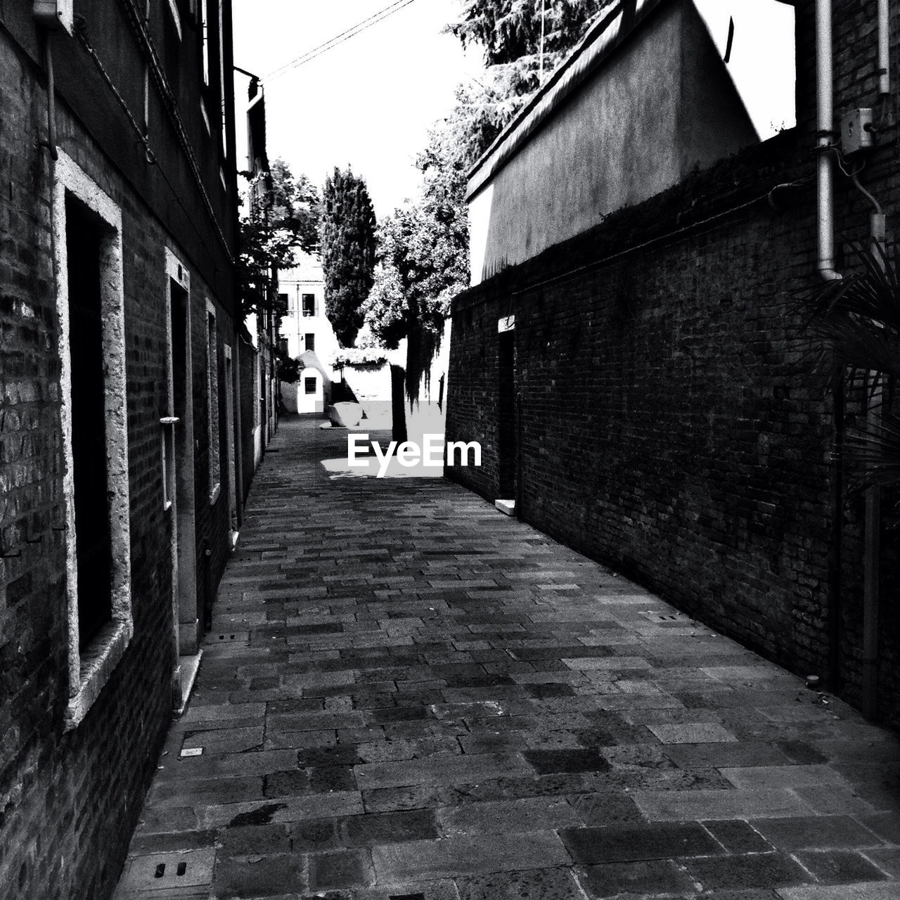 NARROW ALLEY WITH BUILDINGS IN BACKGROUND