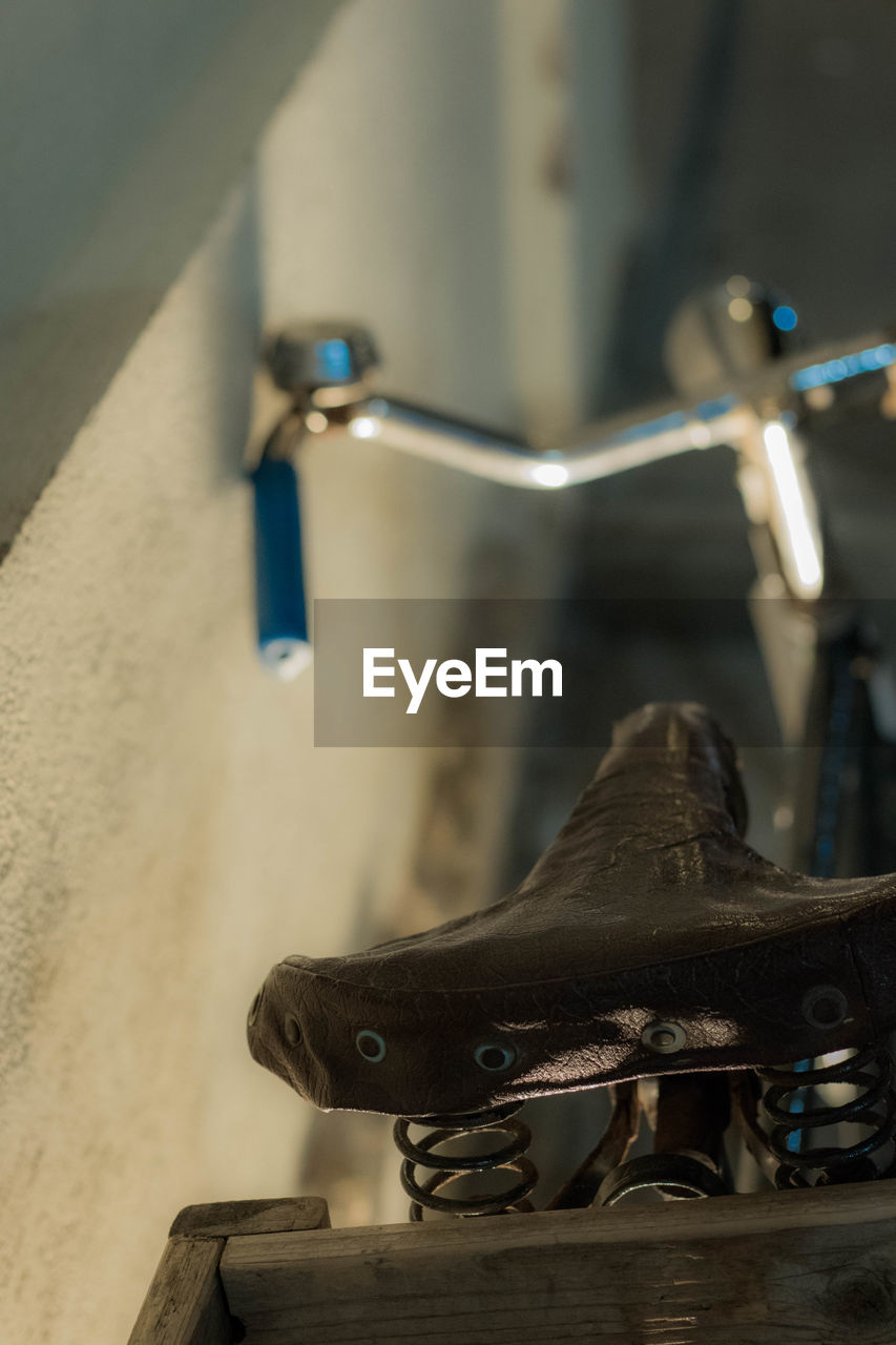 Bicycle parked by wall