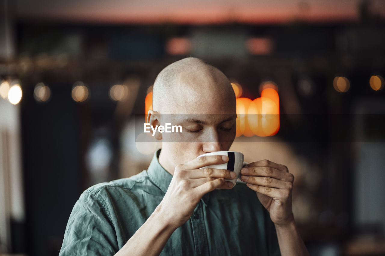 Male cafe owner drinking coffee