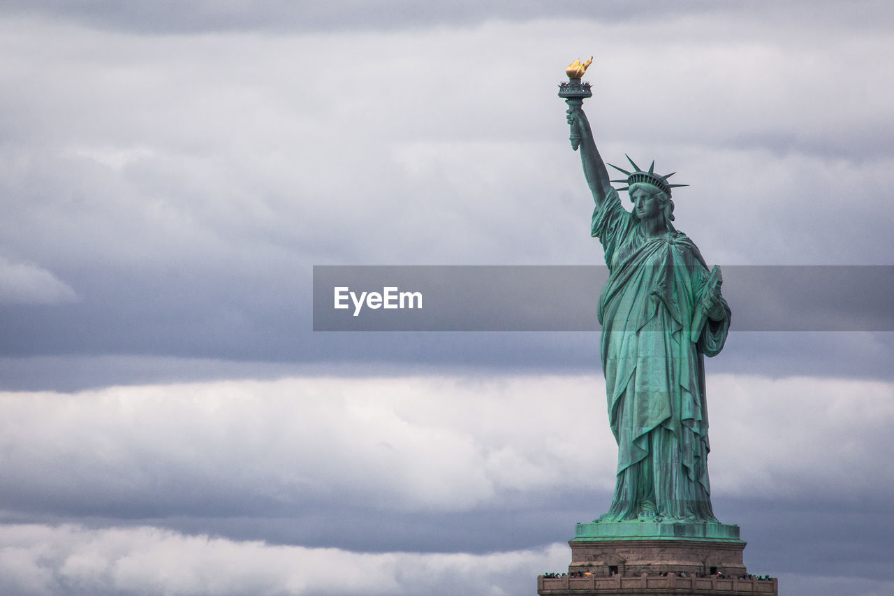 Statue of liberty against cloudy sky