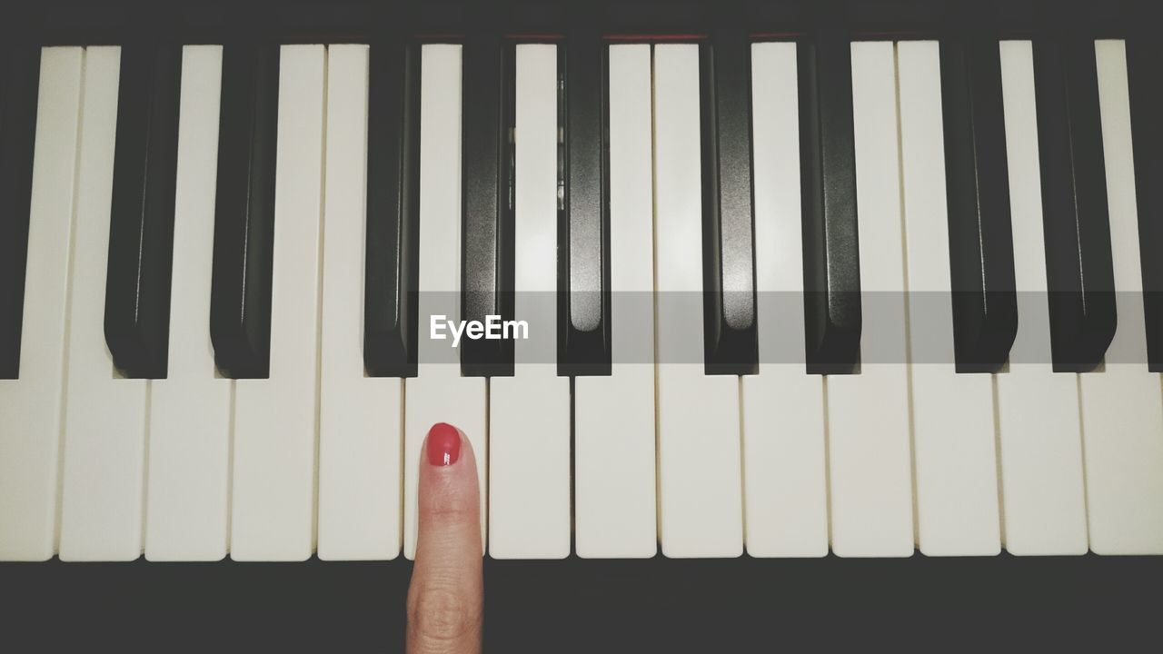 Cropped hand playing piano