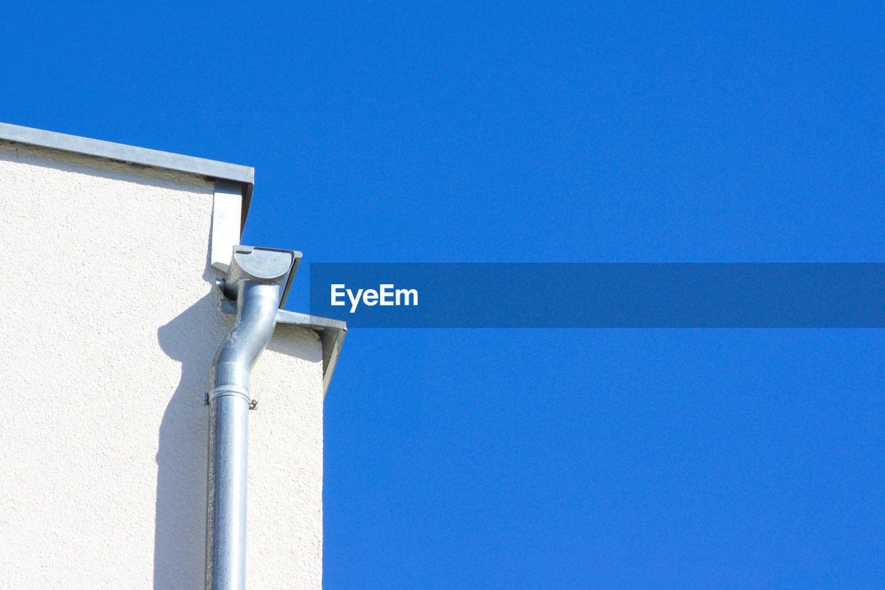 High section of built structure against clear blue sky