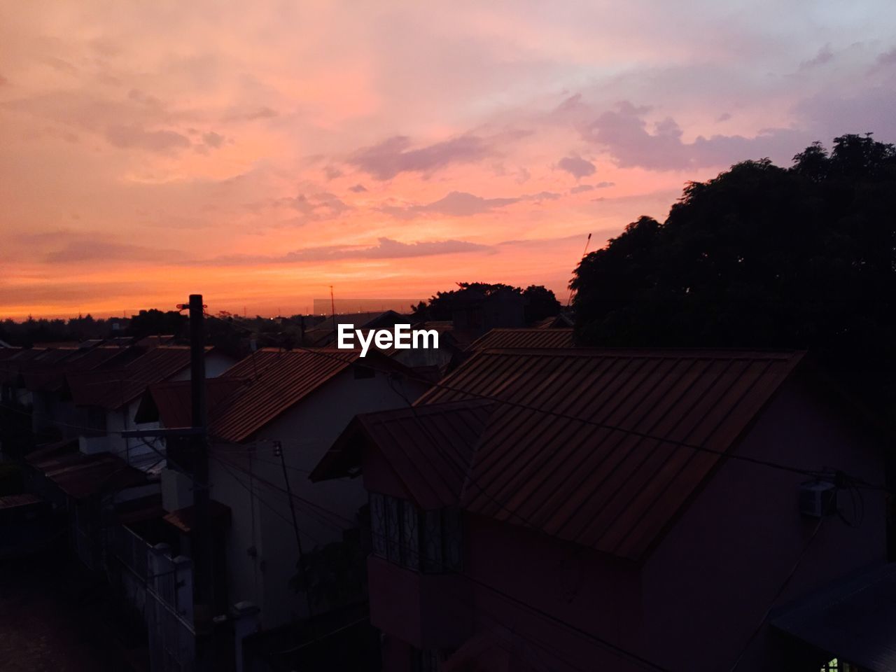 SILHOUETTE OF HOUSE AT SUNSET