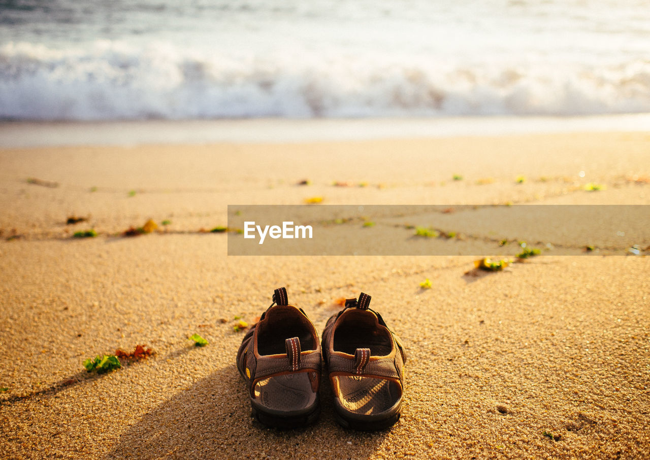 Pair of sandals on sand
