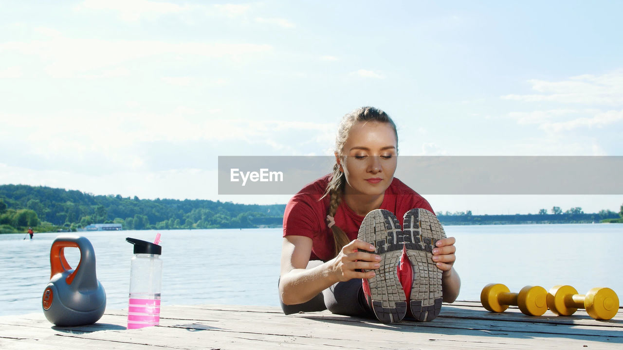 Beautiful, athletic young blond woman, coach, instructor, stretching, doing different exercises. 