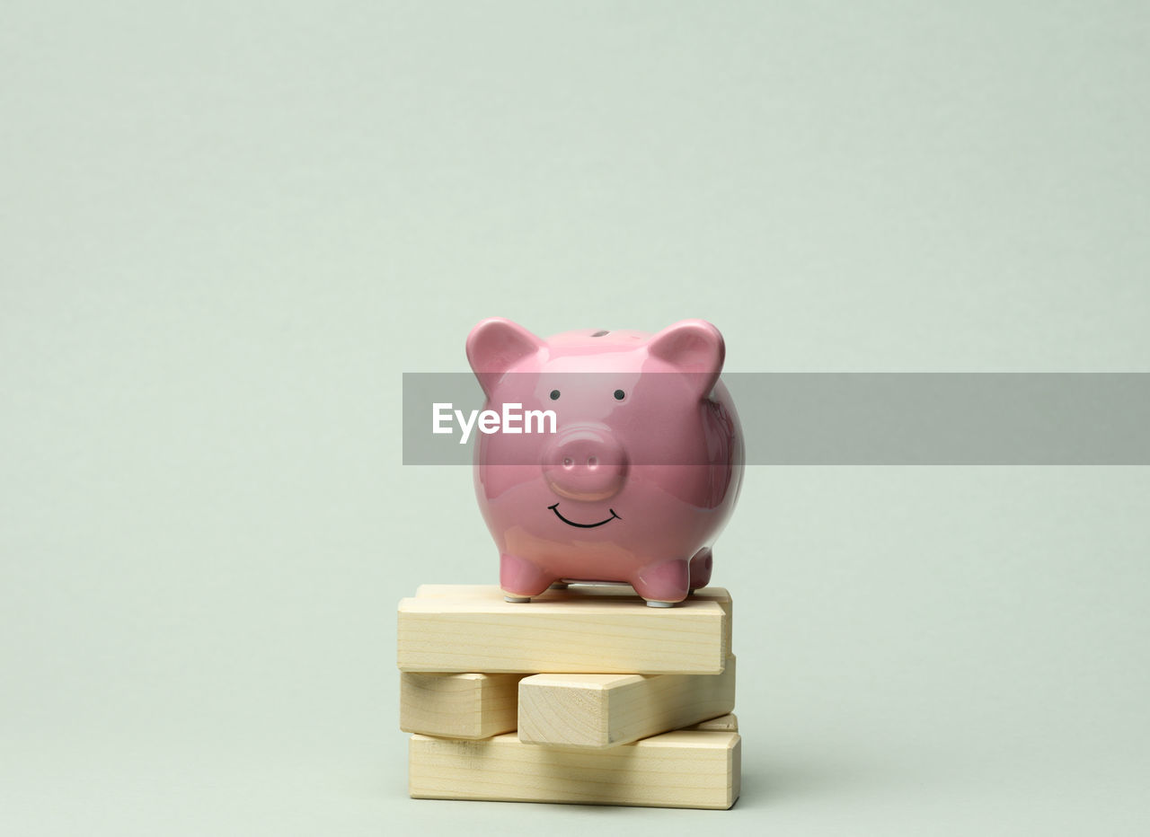 Ceramic pink piggy bank on gray background. concept of increasing income from bank accounts, savings