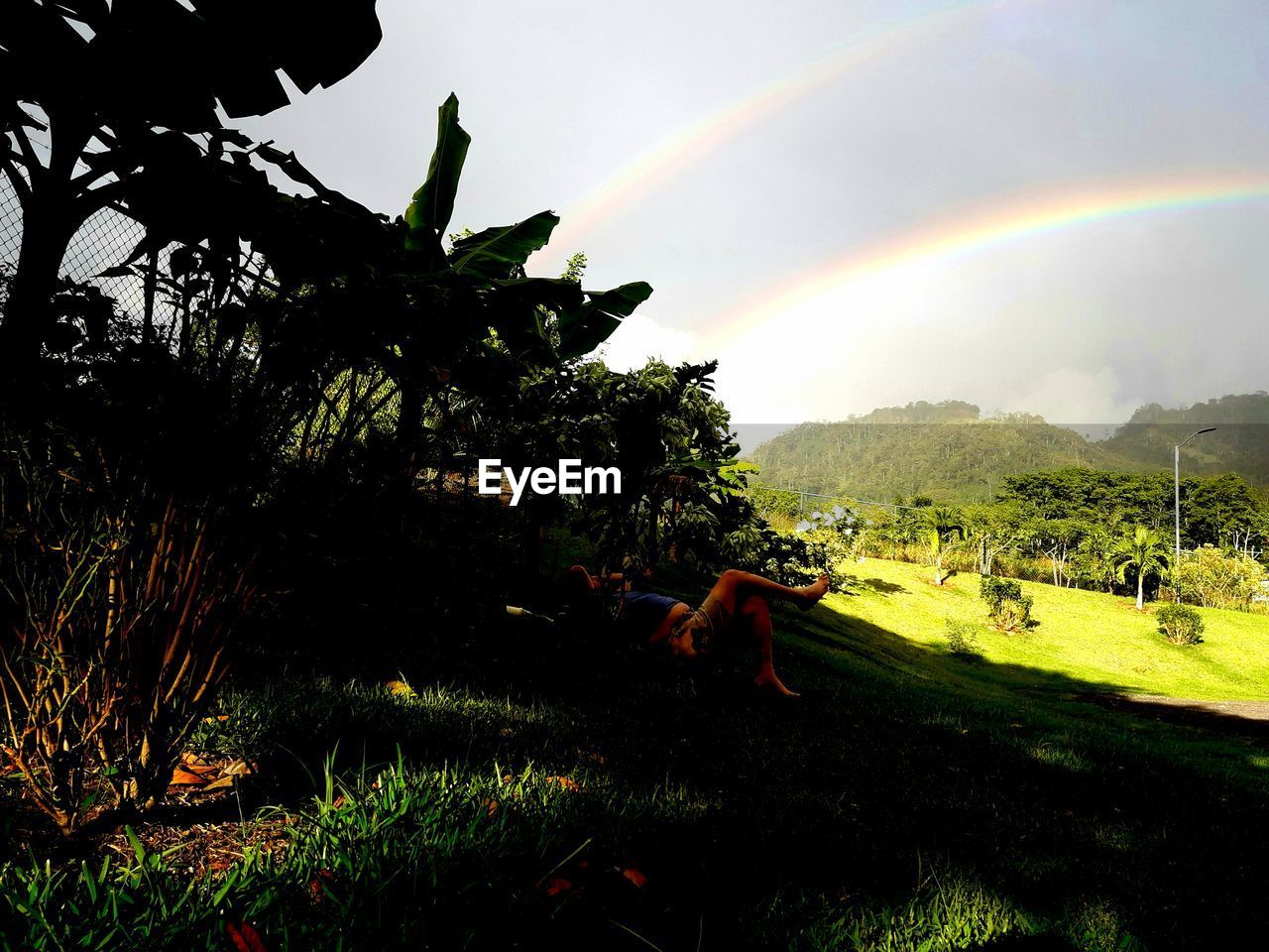 SCENIC VIEW OF RAINBOW OVER FIELD AGAINST SKY