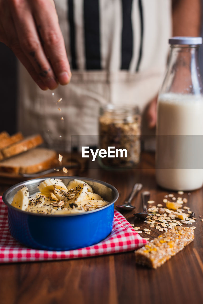 Crop woman preparing healthy breakfast in kitchen