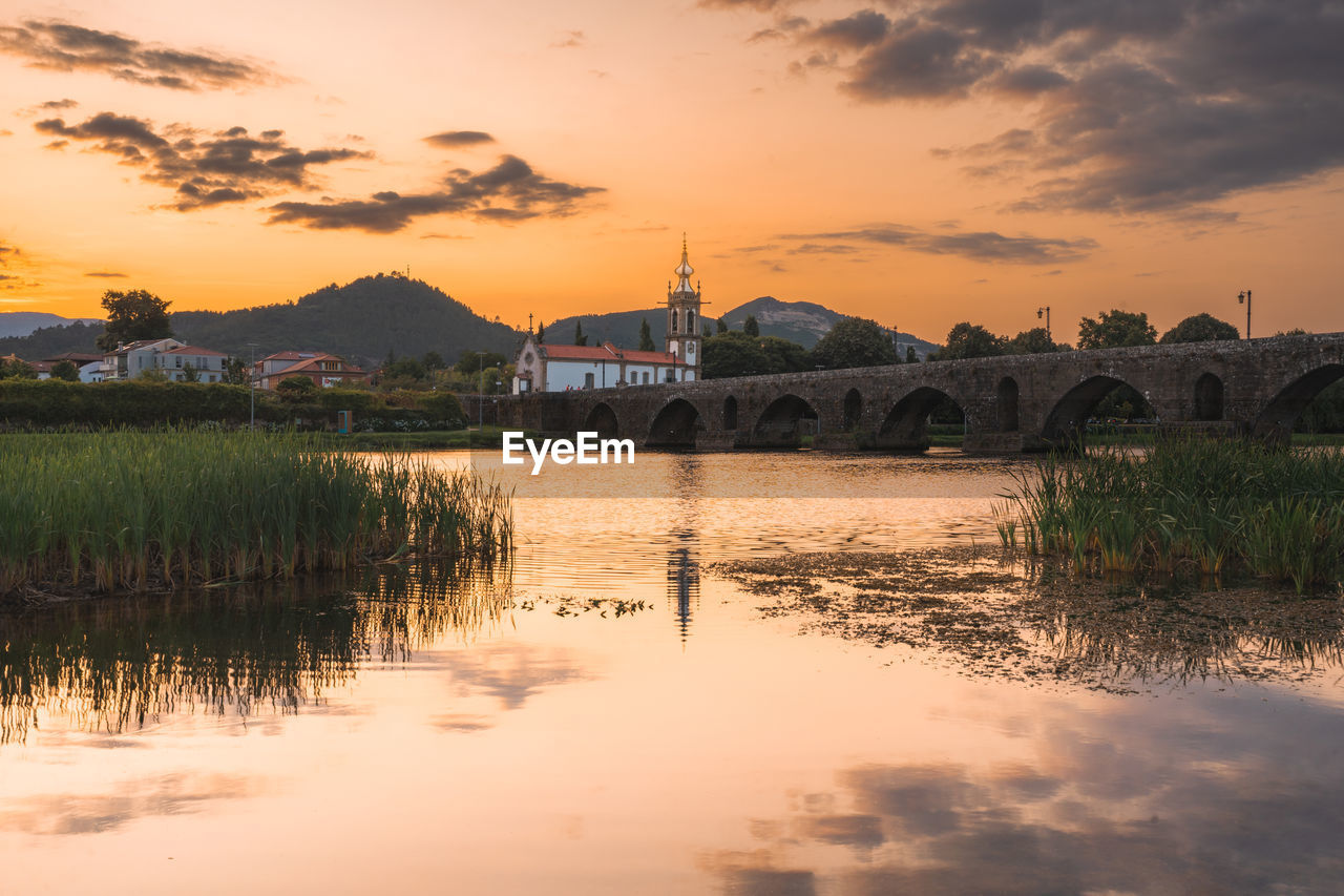 Sunset at the medieval bridge at ponte de lima, portugal.