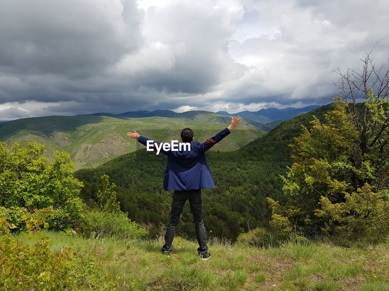 Full length of man standing on mountain against sky