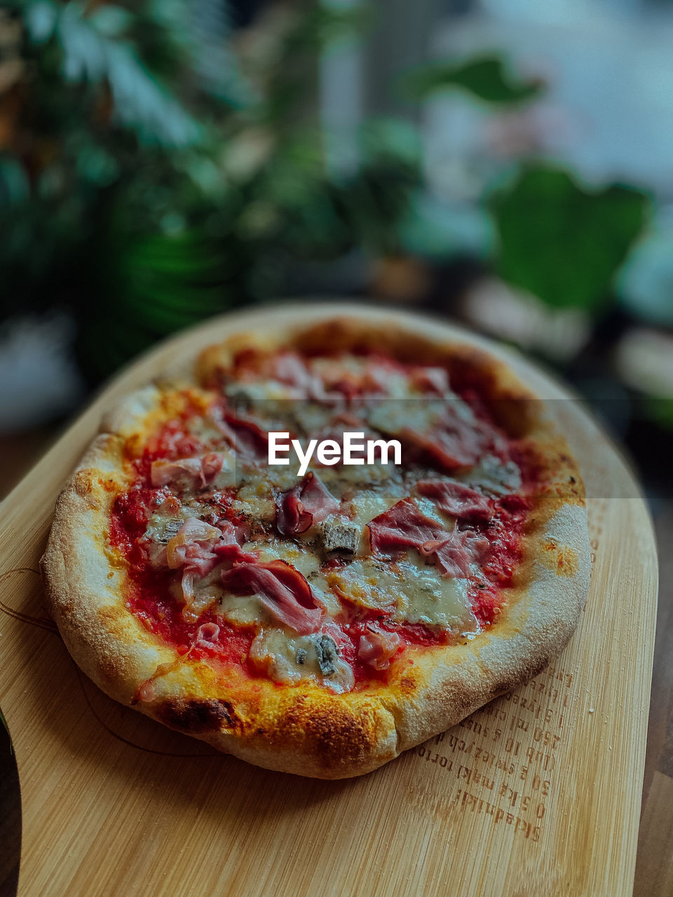 food and drink, food, pizza, fast food, dish, freshness, italian food, dairy, cuisine, wood, no people, fruit, cheese, vegetable, produce, table, baked, healthy eating, indoors, close-up, focus on foreground, plant, meal, dessert, herb, slice, cutting board