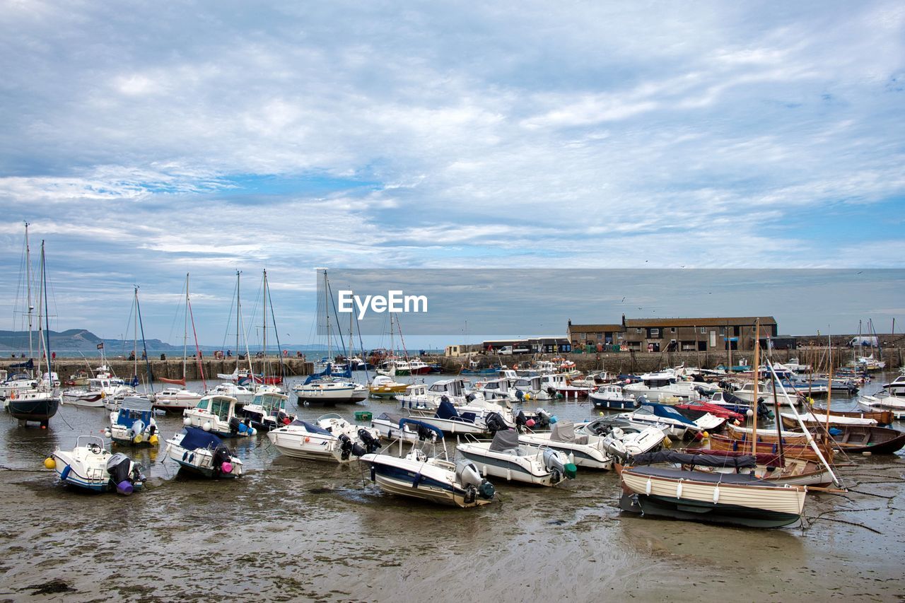 BOATS MOORED AT HARBOR