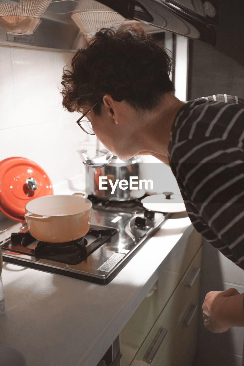 side view of woman preparing food at home